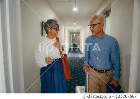 Travel scene of a senior couple riding an elevator 133767667