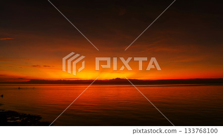Stunning sunset over calm ocean waters Stunning sunset over calm ocean waters 133768100