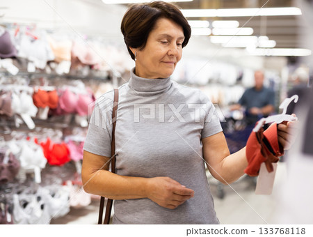 Elderly woman chooses bra in store 133768118