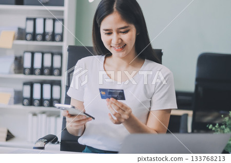 Online payment, Hands of woman holding a credit card and using smart phone for online shopping Online payment, Hands of woman holding a credit card and using smart phone for online shopping 133768213