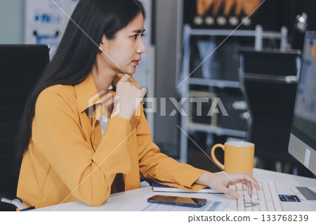 Business woman using calculator for do math finance on wooden desk in office and business working background, tax, accounting, statistics and analytic research concept. Business woman using calculator for do math finance on wooden desk in office and business working background, tax, accounting, statistics and analytic research concept. 133768239