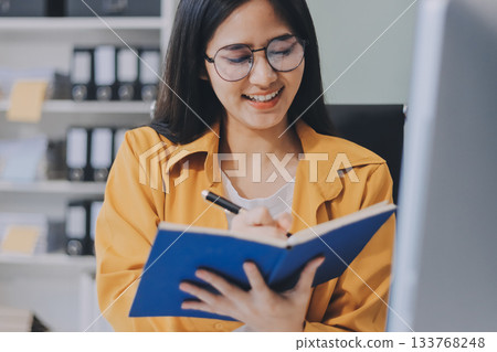 Business woman using calculator for do math finance on wooden desk in office and business working background, tax, accounting, statistics and analytic research concept. 133768248