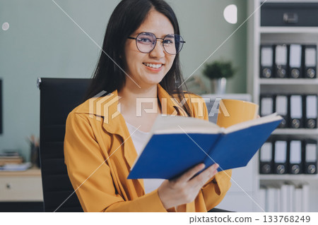 Business woman using calculator for do math finance on wooden desk in office and business working background, tax, accounting, statistics and analytic research concept. Business woman using calculator for do math finance on wooden desk in office and business working background, tax, accounting, statistics and analytic research concept. 133768249