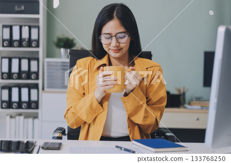 Business woman using calculator for do math finance on wooden desk in office and business working background, tax, accounting, statistics and analytic research concept. 133768250
