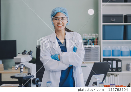 Portrait, science and happy woman on laptop in lab to research chemistry, test or innovation. Microscope, scientist and face of medical doctor in goggles for microbiology, healthcare or pharma study 133768304