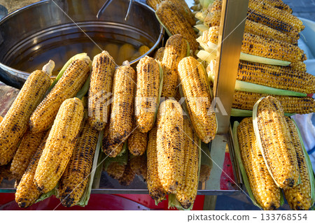 Grilled corn on the cob, a popular street food. Freshly cooked and ready to eat. Grilled corn on the cob, a popular street food. Freshly cooked and ready to eat. 133768554