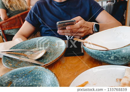 a man using a phone during a meal break 133768839
