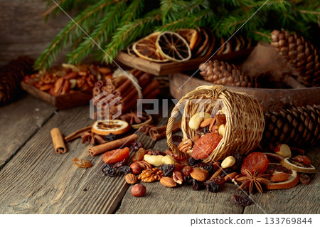 Dried fruits and nuts on an old wooden table. Dried fruits and nuts on an old wooden table. 133769844