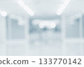 Blurred hospital hallway with bright white lighting and clean blue tone interior 133770142