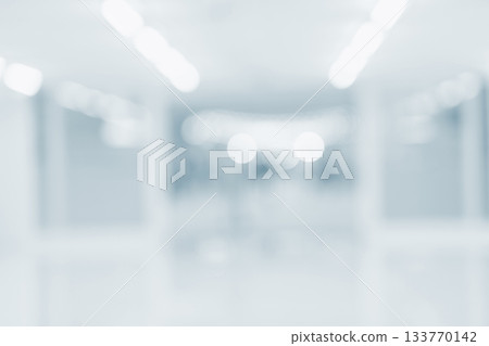 Blurred hospital hallway with bright white lighting and clean blue tone interior 133770142