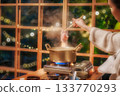 Hot pot cooking with steam rising in cozy restaurant atmosphere 133770293