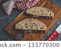 Sourdough bread slices on rustic wooden cutting board 133770300