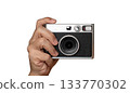 Hand holding retro compact camera isolated on white background 133770302