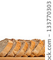 Sliced bread loaf on wooden board with white background 133770303