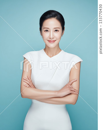 An elegant female model stands out against a refreshing blue background An elegant female model stands out against a refreshing blue background 133770430