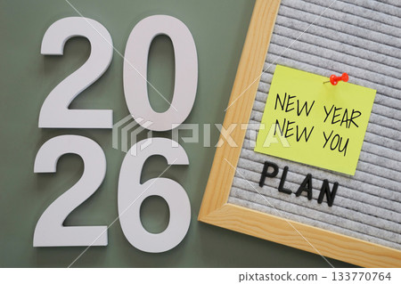 white number of New Year 2026 with word "plan" and post-it paper with text "new year new you" pin on letter board, symbolizing fresh goals, motivation, and starts new year personal fresh planning. 133770764