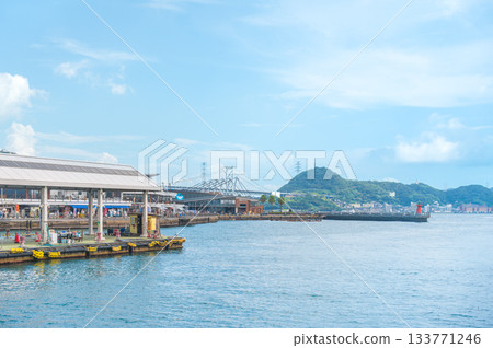Summer seascape of the Kanmon Straits overlooking Shimonoseki Karato Market and the Kanmon Bridge 133771246