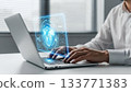 Futuristic Man Typing on Laptop with Holographic Interface Display 133771383