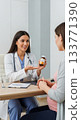 Doctor Explaining Prenatal Vitamins During Consultation with Patient 133771390