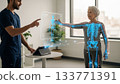 Physical Therapist Demonstrating Rehabilitation with Hologram Interface 133771391