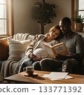 Couple Enjoying Morning Reading in Cozy Living Room with Warm Light 133771392