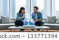 Cheerful Partners Enjoying Futuristic Hologram Display in Living Room 133771394
