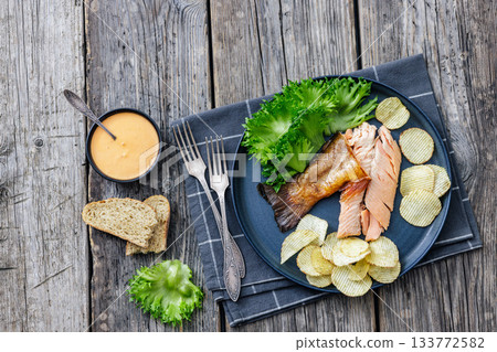 hot smoked trout fillet with lettuce, potato chips hot smoked trout fillet with lettuce, potato chips 133772582