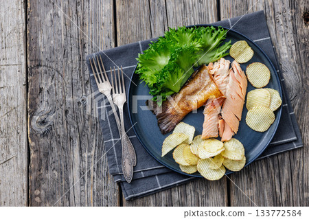 hot smoked trout fillet with lettuce, potato chips hot smoked trout fillet with lettuce, potato chips 133772584