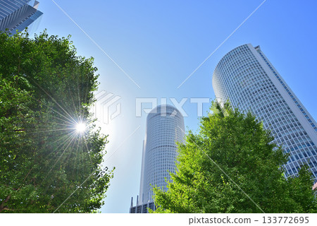 Nagoya Station, looking up at the skyscrapers against the blue sky. 133772695