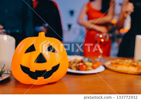 Joyful office Halloween party with coworkers in costumes, celebrating with drinks and laughter, fostering teamwork and festive spirit 133772932