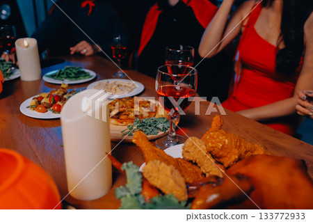 Joyful office Halloween party with coworkers in costumes, celebrating with drinks and laughter, fostering teamwork and festive spirit 133772933