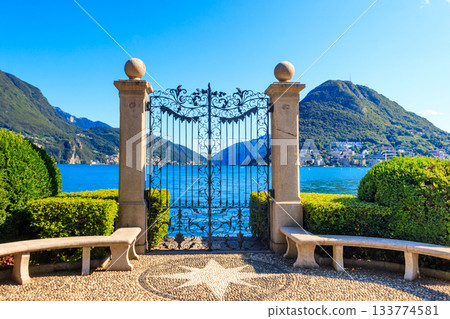Old wrought iron gate overlooking Lake Lugano in Ciani Park, Lugano, Switzerland 133774581
