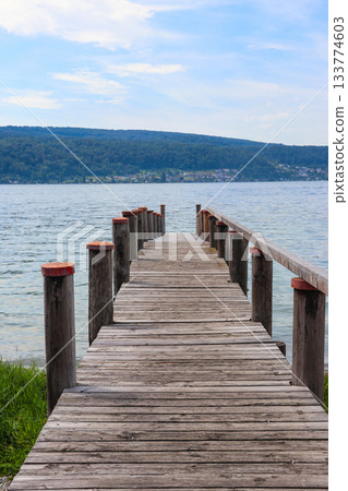 Wooden pier overlooking the Alps and Lake Constance in Switzerland 133774603