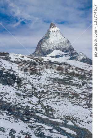 Scenic view on snowy Matterhorn mountain peak in sunny day with blue sky in Switzerland. Beautiful nature background of Swiss Alps covered with snow. Famous travel destination 133774617