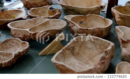 Wooden bowls display, Closeup of artistically crafted burl wood bowls with textured finish, Arrangement of meticulously crafted burl wood bowls emphasizing grain patterns and artisan 133774685