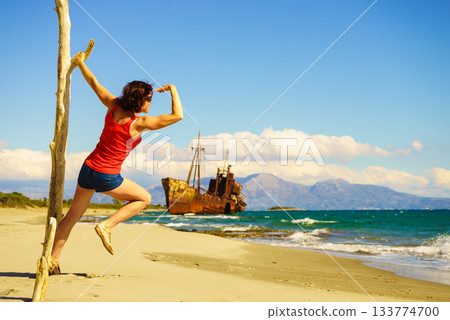 Tourist woman on beach enjoying vacation Tourist woman on beach enjoying vacation 133774700