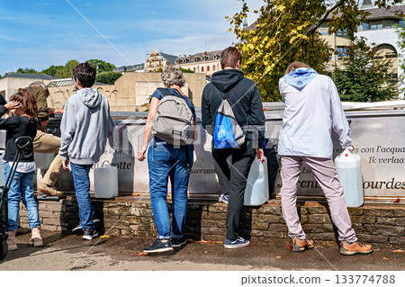 Pilgrims to the Sanctuary of Lourdes in France filling up bottle Pilgrims to the Sanctuary of Lourdes in France filling up bottle 133774788