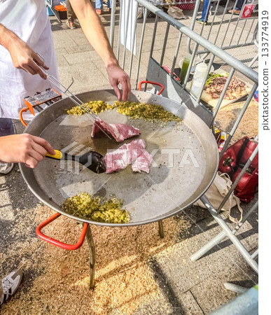 Searing Raw Meat and Sofrito Base in Large Paella Pan Searing Raw Meat and Sofrito Base in Large Paella Pan 133774919