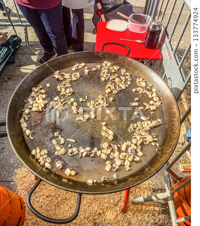 Sizzling Calamari and Squid Rings Cooking in Paella Pan 133774924