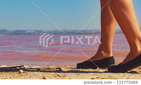 Woman on pink lake in Spain Woman on pink lake in Spain 133775069