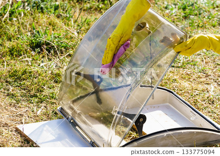 Woman cleaning old caravan sunroof Woman cleaning old caravan sunroof 133775094