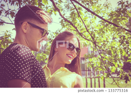 Smiling couple in park Smiling couple in park 133775316