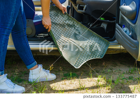 Woman cleaning car interior Woman cleaning car interior 133775487
