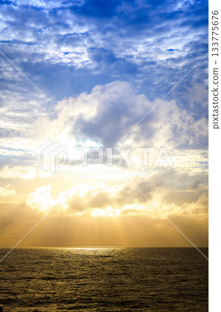 Dramatic ocean sky and clouds with sunlight streaming in Dramatic ocean sky and clouds with sunlight streaming in 133775676