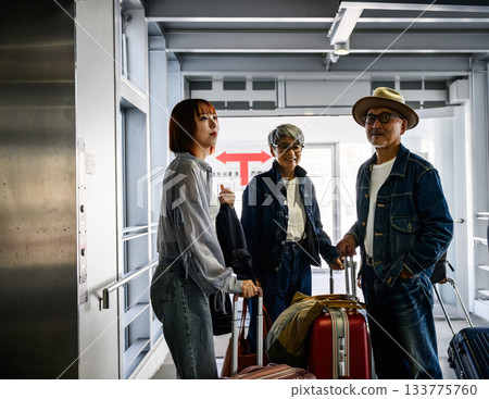 A young woman and an elderly couple going on a trip, 133775760