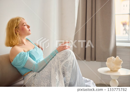 contemplative blonde woman indoors, elegant woman in pastel outfit contemplating inside environment 133775782