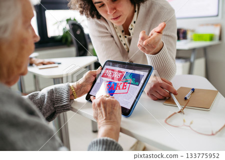 Elderly woman learning digital skills with tutor help. Elderly woman learning digital skills with tutor help. 133775952