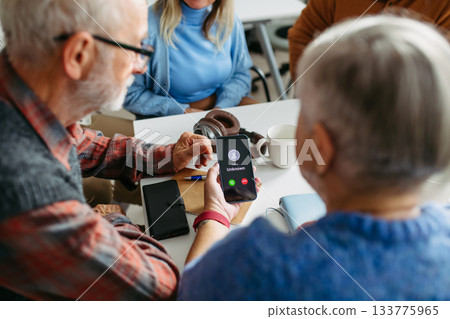 Tutor teaching seniors about phone scams and digital safety. 133775965