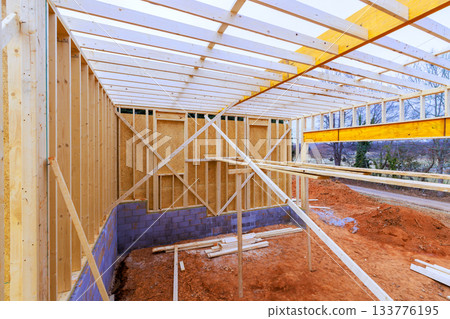 Construction of new building with wooden framing foundation work taking place 133776195