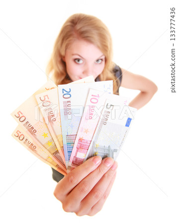Economy finance. Woman holds euro currency money. 133777436